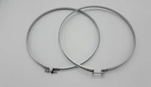 Zwei metallene Klemmbänder, die leicht übereinander liegen. Sichtbare Schraubverschlüsse zur Befestigung. Eines der Bänder trägt das Logo von Remeha.